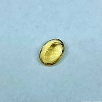 Single oval faceted citrine on neutral background
