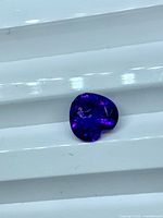 Front view of heart cut amethyst showing deep purple color and facets