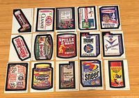 Fronts of 15 Wacky Packages stickers laid out in three rows