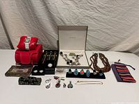 Full view of lot showing jewellery pieces, boxes, pens and accessories on table