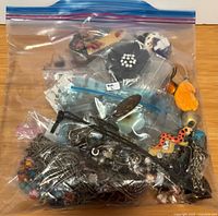 Sealed gallon bag showing assorted jewelry inside