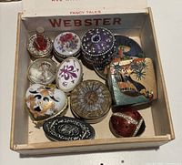 Group of trinket boxes inside Webster box