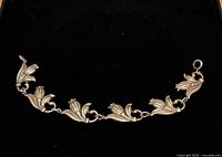 Full view of sterling tulip bracelet against black background