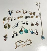 All jewelry pieces laid out showing earrings, bracelet, necklace