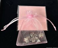 Charms inside pink organza pouch