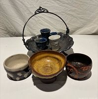 All pottery bowls and cups with silver plated dish