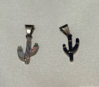 Front view of both sterling cactus pendants