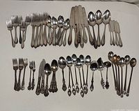 Overall view of both rows of silverplated flatware, showing quantity and variety