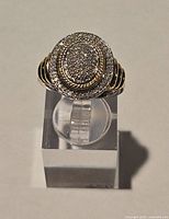 Front view showing oval pave diamond top and yellow gold accent shoulders