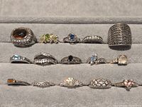 Front view showing 14 of the sterling gemstone rings arranged in rows
