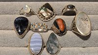 Front view of nine sterling gemstone rings