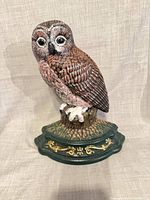 Front view of cast iron owl figurine on green base