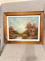 Front view of framed oil landscape painting