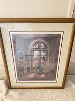 Front view of framed poster showing artwork, frame, mat