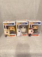 Front view of all three boxed figures: Rose Tyler #295, Adipose #225, Ninth Doctor With Banana #301