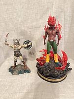 Barbarian resin figure and larger flame figure side by side