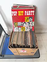 Box of upright LPs with "Pop Hit Party" album facing front