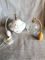 Front view of both perfume atomizer bottles