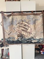 Full tapestry on display rod showing overall design and condition