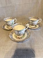 Three Royal Albert teacups on matching saucers front view