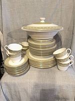 Full set stacked showing tureen on top, plates, cups
