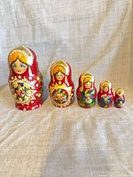 All five nesting dolls lined up from largest to smallest