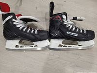 Both Bauer skates side view showing boot condition and blade holders