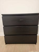 Front view of dark brown 3-drawer chest