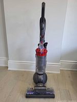 Front view of Dyson ball vacuum showing cyclone, clear bin, cleaner head and ball base