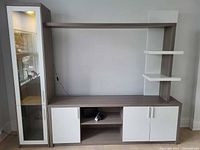 Full view of assembled entertainment wall unit showing display cabinet, TV stand, bridge shelf and side shelving