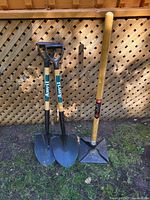 Two Anvil shovels and Razorback tamper leaning against lattice fence
