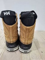 Rear view showing heel, pull tabs, HH logo, condition of leather and rubber.