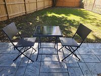 Bistro set displayed on patio showing full table and two chairs