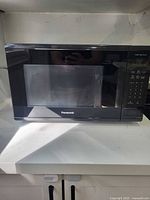 Front view of black Panasonic countertop microwave oven