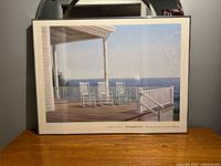 Full view of framed Ocean Rest poster on table