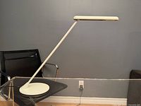 Lamp side profile showing angled arm, base, and light head