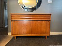 Front view showing drawers, sliding doors, legs