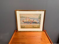 Full view of framed painting on wooden surface