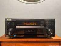 Full front view displaying powered-on receiver with display lit