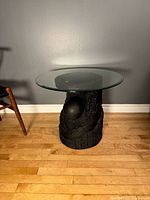 Overall view of side table showing glass top and full base