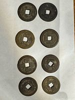 Eight Qianlong Tongbao coins front and back views