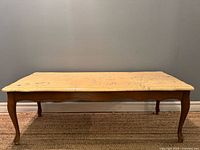 Front view showing full table, wooden frame and cabriole legs