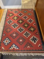 Full view of wool kilim rug laid on floor