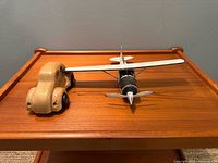 Wooden car and metal airplane on table