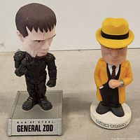 Front view of both bobbleheads showing details and labels