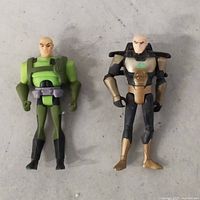 Front view of two Lex Luthor figures, showing color schemes and articulation