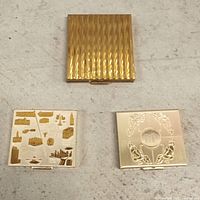 Three closed compacts showing exterior designs