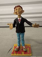 Front view of Alfred E. Neuman figure on MAD base