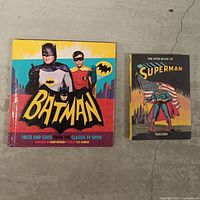 Front covers of both Batman and Superman hardcover books
