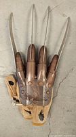 Front view of Freddy Krueger glove showing metal blades and finger plates